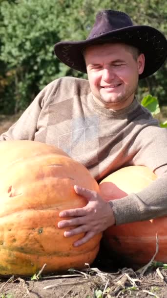 Young Farmer Smile His Face Hugs Big Ripe Yellow Pumpkin — Stock Video