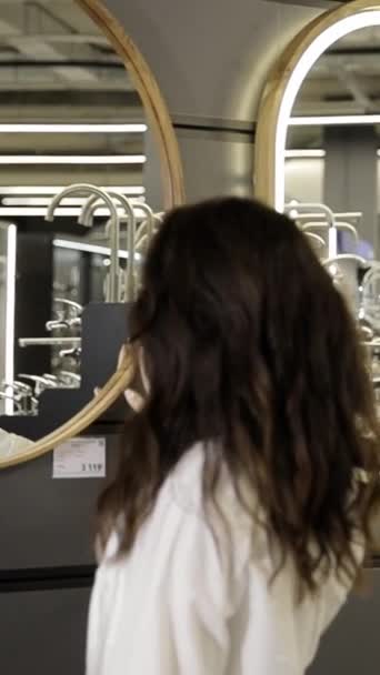 Woman Examines Mirror Bathroom Reconstruction Bathroom Repair Idea Vertical Video — Stock Video
