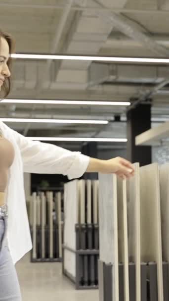 Woman Examines Different Types Ceramic Tiles Hardware Store Concept Repair — Stock Video