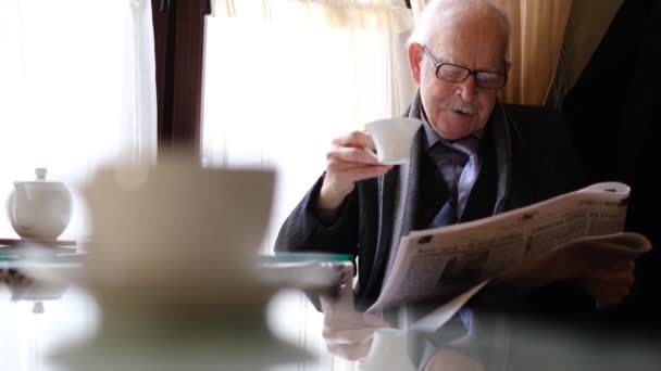 Elderly Man Glasses Cafe Drinks Coffee Reads Newspaper Leisure Information — Stock Video