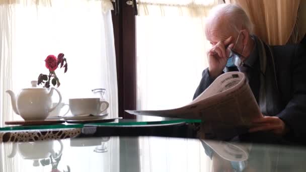 Sick Old Grandfather Blue Protective Mask Sits Kitchen Table Reads — Stock Video