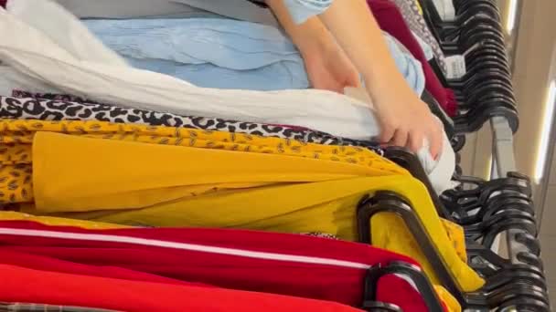 Μια Γυναίκα Εξετάζει Ρούχα Κατάστημα Γυναικών Ψώνια Για Ρούχα Εκπτώσεις — Αρχείο Βίντεο