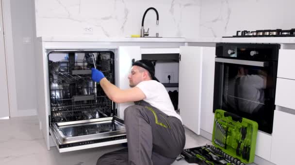 Reparador Con Mono Revisa Lavavajillas Cocina Después Instalarlo Reparación Electrodomésticos — Vídeos de Stock