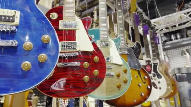 Багато Електронних Бас Гітар Висять Стіні Магазині — стокове відео