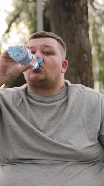 Fat Man Drinks Water While Exercising Outdoors Overweight Man Weight — Stock Video