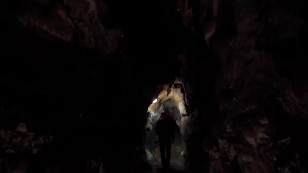 Professional Speleologist Illuminates Explores Dark Stone Cave — Stock Video