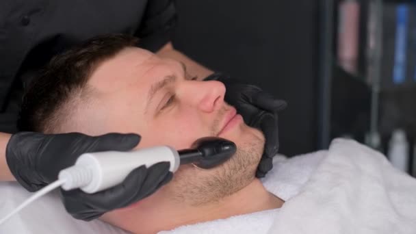 在美容院接受射频整容的大胡子男子的特写镜头 男人接受年轻的面部整容 面部按摩和皮肤护理 — 图库视频影像