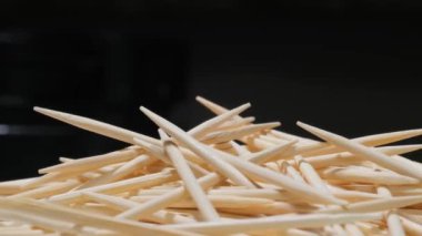 Siyah arka planda bambu kürdanları. Diş temizlemek için tahta çubuklar..