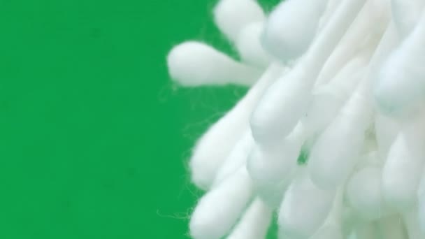 白い色の綿棒は緑の背景の円で回転する 衛生製品について バーティカルビデオ — ストック動画