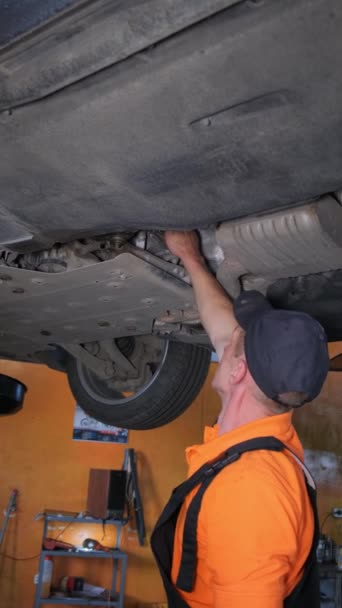 修理工修理汽车底盘的技工 垂直录像 — 图库视频影像