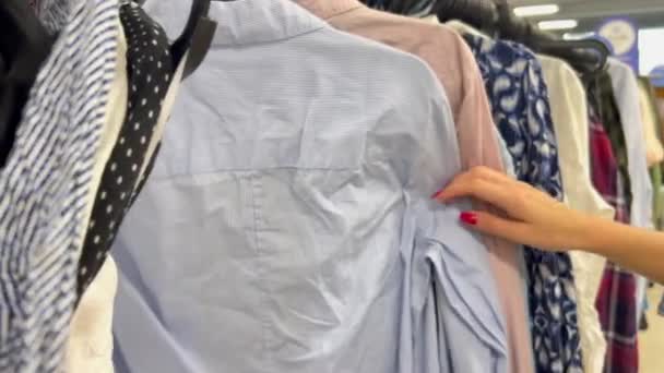 Selection Second Hand Clothes Close Womans Hand Choosing Clothes Racks — Stock Video