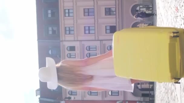 Een Vrouw Met Een Gele Koffer Gaat Naar Een Hotel — Stockvideo