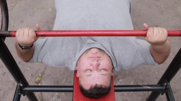 Fat Man Gray Shirt Lifts Weights While Lying Outdoor Exercise — Stock Video