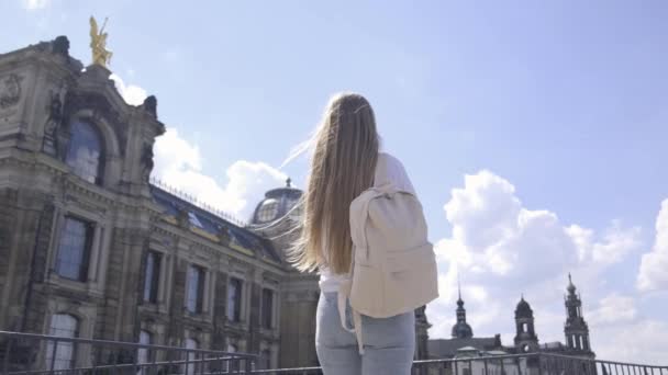 Eine Frau Mit Einem Rucksack Geht Gebäude Entlang Und Genießt — Stockvideo
