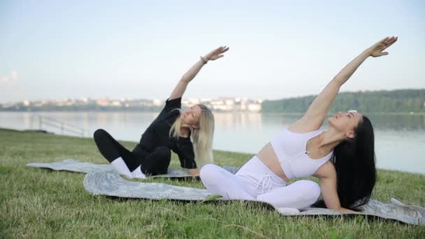 Twee Jonge Vrouwen Doen Morgens Yoga Aan Oever Van Het — Stockvideo