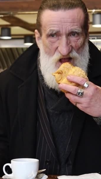 Közelkép Egy Gazdag Öregemberről Aki Egy Kávézóban Egy Croissant Eszik — Stock videók