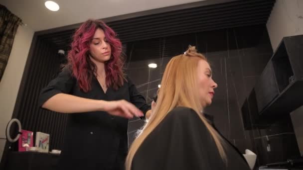 Fryzjerka Stylizuje Włosy Długowłosej Blondynki Średnim Wieku Pielęgnacja Włosów Profesjonalnego — Wideo stockowe