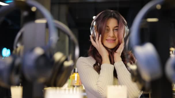 Young Positive Girl Listens Music New Headphones Buying Headphones Digital — Stock Video