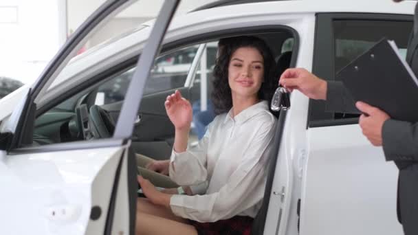 Młoda Atrakcyjna Brunetka Siedzi Kierownicą Nowego Samochodu Salonie Samochodowym Sprzedawca — Wideo stockowe