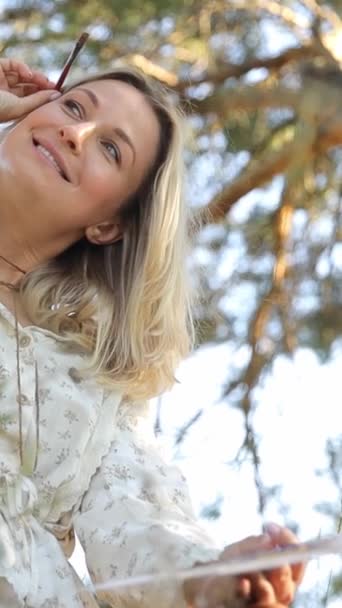 Happy Woman Sits Tree Smiling Holding Painting She Surrounded Nature — Stock Video