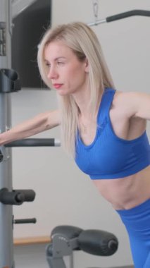 Güzel bir kadın spor salonunda sırtını çalıştırıyor. Spor yaşam tarzı konsepti.