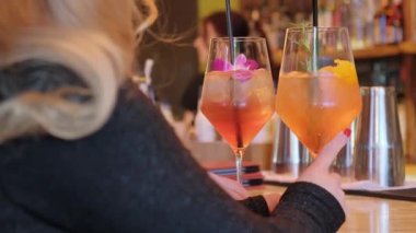 Renkli çiçekler ve nefis narenciyelerle süslenmiş iki güzel kokteyl, şık bir gece için ideal.