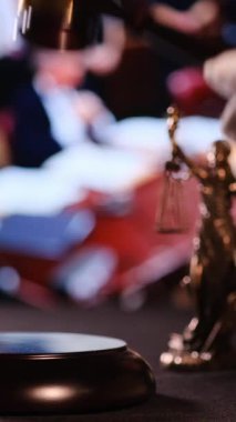 Yargıç, adaleti ve nihai yasal kararları simgeleyen tokmağı mahkeme salonunda vuruyor. Dikey video. 