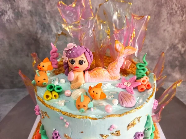 Birthday cake with a 3D mermaid theme shaped using fondant