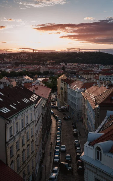 Gün batımında Prag 'ın Vyehrad' ından şehrin manzarası. Tarihi binalar, çatılar, park edilmiş arabalar..