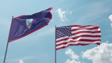 Guam bayrağı ve ABD bayrağı bayrak direği üzerinde güçlü bir rüzgar üzerinde mavi gökyüzünde güçlü bir rüzgar ekran koruyucu veya giriş olarak. ABD 'nin Guam ve Amerika Birleşik Devletleri toprakları