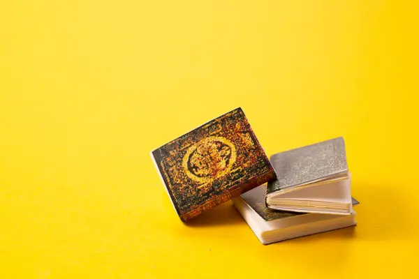 A simple composition of books on yellow background.