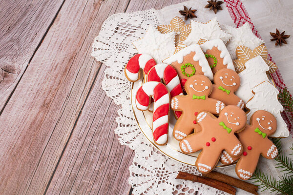 Christmas bake tools on flour and rustic wooden background, top view., flat lay. Traditional biscuits molds for winter holidays.Copy space.