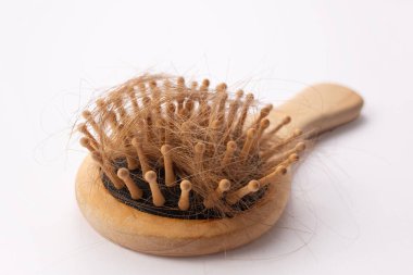 Saç kaybı beyaz arka planda izole edilmiş tarak fırçasıyla olur. Saç dökülmesi konsepti. Kapat..