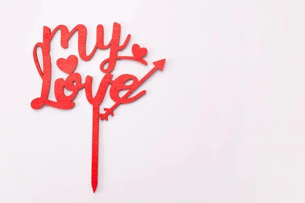 The word my love in wooden red letters on white background. Valentines day concept.