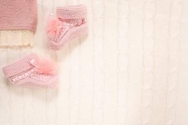 Pembe örülü çoraplar ve beyaz arka planda bir şamata. Uzayı kopyala Bebek doğumu konsepti