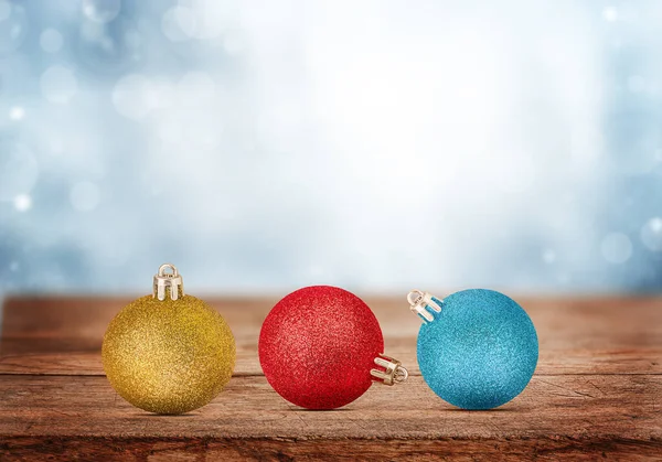 Christmas ornaments on wooden table on winter background.