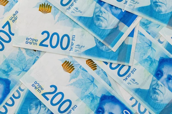 Yığınla NIS 200 Yeni İsrail Şekeli banknotları. Şekel duvar kâğıdı İsrail Finans arka planı. Üst Manzara. Zengin yaşam kavramsal geçmişi. Büyük miktarda para..
