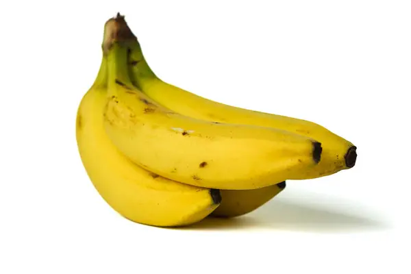 Beyaz arka planda izole edilmiş bir grup muzun yakın plan portresi.