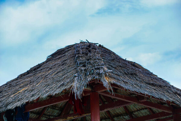 Portrait of a Gazebo with traditional roof tiles made of straw