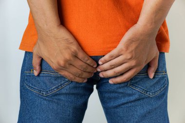 Health care, Asian men suffering from hemorrhoids, anus, diarrhea and constipation, men's hands touching, holding buttocks, rectum.