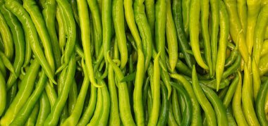 Close-up of green peppers at a street shop counter. Background, texture. clipart