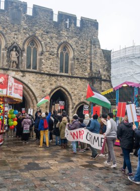 Protest walk calling for stop war crimes, Southampton , UK,  16 December, 2023. They carrying protest signs.