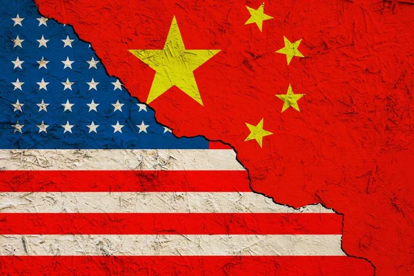 Demonstration of the conflict between the US and China. Flag of the American regime and the Chinese regime on a cracked clay wall.