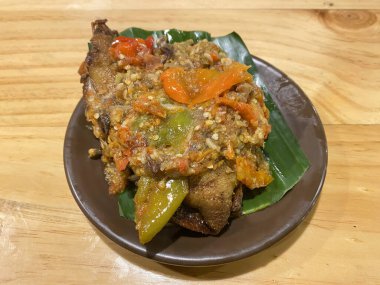 Baharatlı biber soslu kızarmış ördek ve muz yaprağında domates, tipik geleneksel Endonezya yemeği.