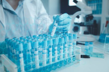 Kimyager test tüplerini kimyasal olarak analiz ediyor. Bilim adamı laboratuvarda kimyasallar üzerinde deney yapıyor. Kimyager test tüplerindeki bileşikleri kimyasal reaktörlerle ayırıyor.,