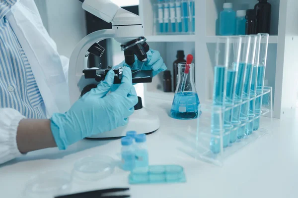 Kimyager laboratuvarda bir deney yapıyor, bir bilim adamı kimyasal bileşimi analiz etmek için mikroskop kullanıyor, bilimsel bir deney laboratuvarda biyolojik cevaplar arıyor.,