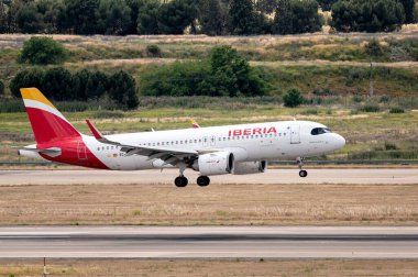 Madrid, Spain; 05-18-2024: Airbus A320 model airplane of the Spanish company Iberia starting the landing maneuver with the landing gear deployed clipart