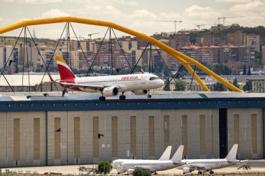 Madrid, Spain; 05-18-2024: Airbus A320 model airplane of the Spanish company Iberia starting the landing maneuver with the landing gear deployed clipart