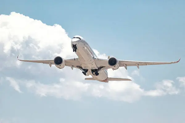 stock image Madrid, Spain; 05-24-2024:Airbus A350 model aircraft of the Spanish company Iberia during the takeoff maneuver, storing the landing gear while gaining altitude