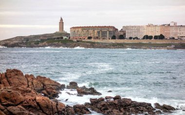 Riazor beach bay in the Spanish city of A Coruna and the Hercules tower lighthouse in the background clipart